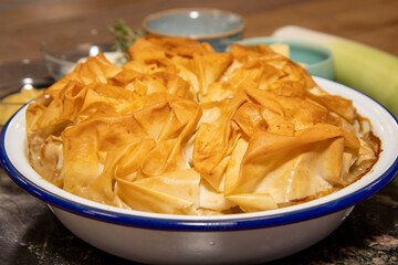 A delicious chicken and wild mushroom pie on a wooden table