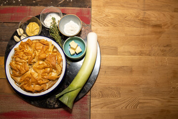 A delicious chicken and wild mushroom pie on a wooden table