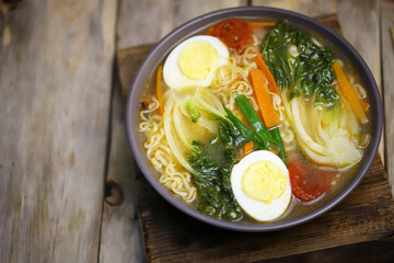 Noodle soup with egg and bok choy cabbage. Chinese style broth.