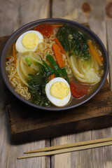 Noodle soup with egg and bok choy cabbage. Chinese style broth.