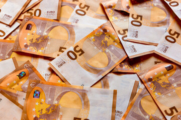 A close-up shot of a heap of 50 (fifty) euro banknotes: background