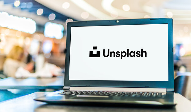 Laptop computer displaying logo of Unsplash