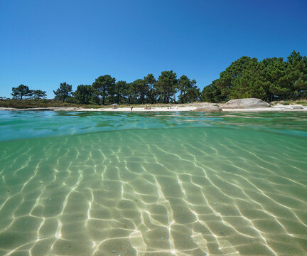 Spain Galicia, beach coastline in summer and sand underwater, Atlantic ocean, split view over and under water surface, Pontevedra province, Illa de Arousa