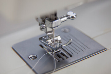 details of the sewing machine. working at home at a sewing machine.
