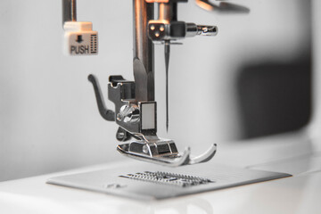 details of the sewing machine. working at home at a sewing machine.
