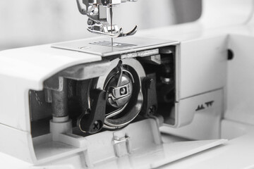 details of the sewing machine. working at home at a sewing machine.
