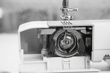 details of the sewing machine. working at home at a sewing machine.
