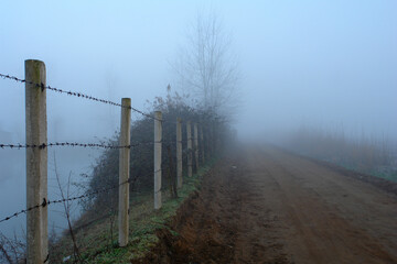 fence in the fog in foggy morning