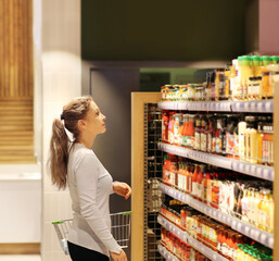 Woman choosing a dairy products at supermarket	
