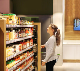 Woman choosing a dairy products at supermarket	
