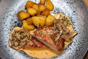 A delicious plate of pork stroganoff and pan fried potatoes