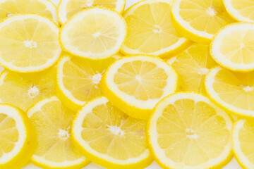 Some vitamin rich lemons cut and placed side by side as a background