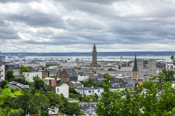 Naklejka premium Panoramic view of Le Havre from Hanging gardens (Jardins Suspendus). Port of Le Havre with portal cranes and containers on the background. Le Havre, France.