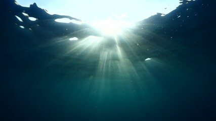 sun ray and sun beam scenery underwater waves on surface of water slow ocean scenery