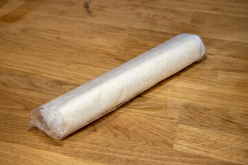 A bag of frozen pastry on a wooden kitchen work top