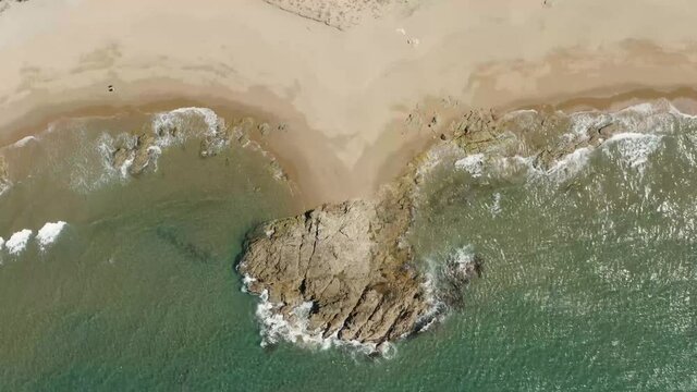 Aerial view of waves and beach.