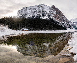 Fototapeta premium Beautiful winter view of a wooden cabin at Lake Louise, Canada