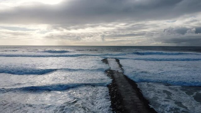 Aerial View of Costa da Caparica beach wave breaker, Portugal