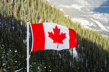 Beautiful view of the Sanson's Peak with a canadian flag in the foreground, at Banff Gondola, Canada