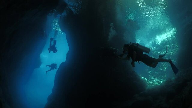 scuba divers exploring caves underwater cave diving