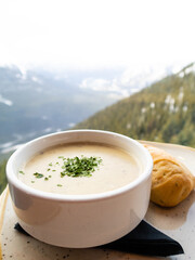 Bowl of soup with a mountain landscape in the background
