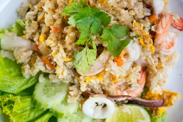 Shrimp fried rice on a wooden table from a top view