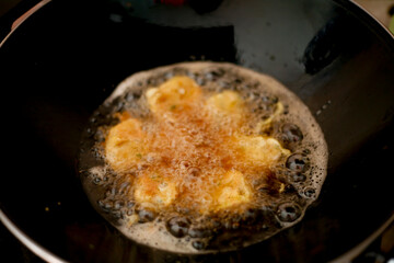 fried indonesian food called perkedel in a frying pan