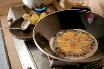 fried indonesian food called perkedel in a frying pan 
