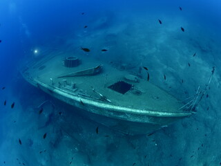 scuba divers exploring shipwreck scenery underwater ship wreck deep blue water ocean scenery of...