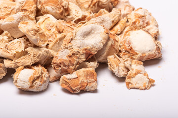 Sand ginger, latin name Kaempferia galanga dried roots heap close-up view on white background