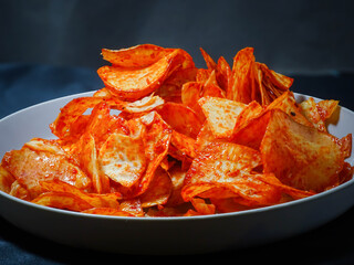 spicy cassava chips isolated on black background