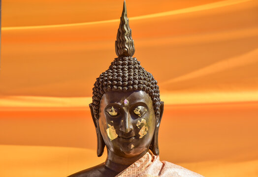 Buddha statue on yellow background.