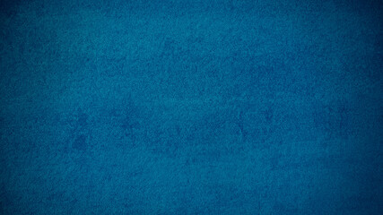 abstract blue mortar or stucco wall texture background with dark gradient from corners. vignette blue stucco background.