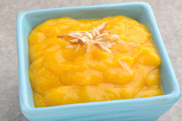 aam ras or mango pulp with almond topping, Indian traditional mango recipe