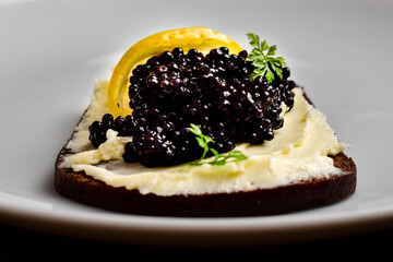 Black sturgeon caviar on bread with parsnip puree