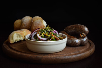 Spicy purslane salad with onions and sausage