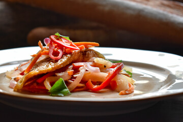 Escabeche. Fried fish marinated with vegetables
