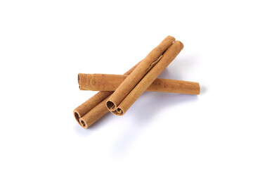 Heap of cinnamon sticks on white