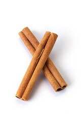 Heap of cinnamon sticks on white
