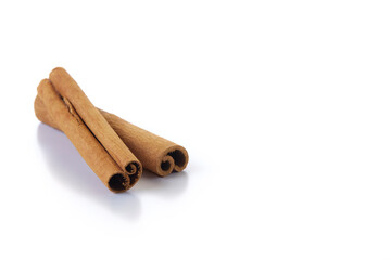 Heap of cinnamon sticks on white