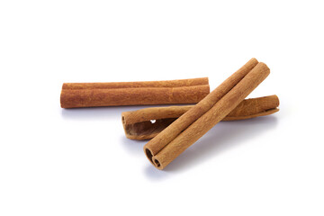 A heap of cinnamon sticks on white background
