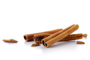 A heap of cinnamon sticks on white background