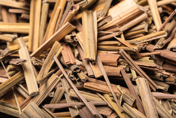 Organic dried lemongrass, latin name cymbopogon citratus heap extreme close-up view on white background