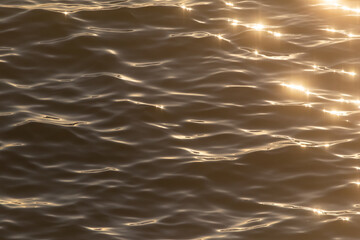 art photography,soft waves with sun reflection on the water surface.