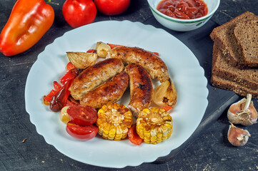 Homemade fried sausages with vegetables on a plate