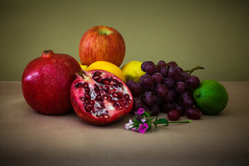 Still life with fruits and a floral arrangement in the foreground