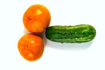 Stock Foto Closeup of yellow orange tomato and cucumber isolated on white background
