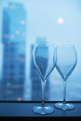 Cocktail glasses on the windowsill by the glass