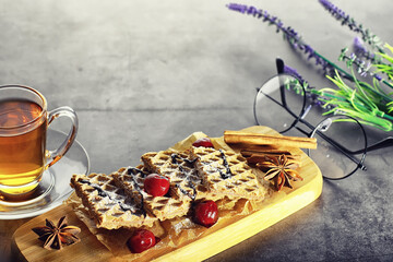 Sweet dessert with waffles and berries for tea at work.