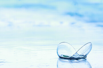 Tools for vision correction. Glasses and lenses with diopters on the background of splashes and...